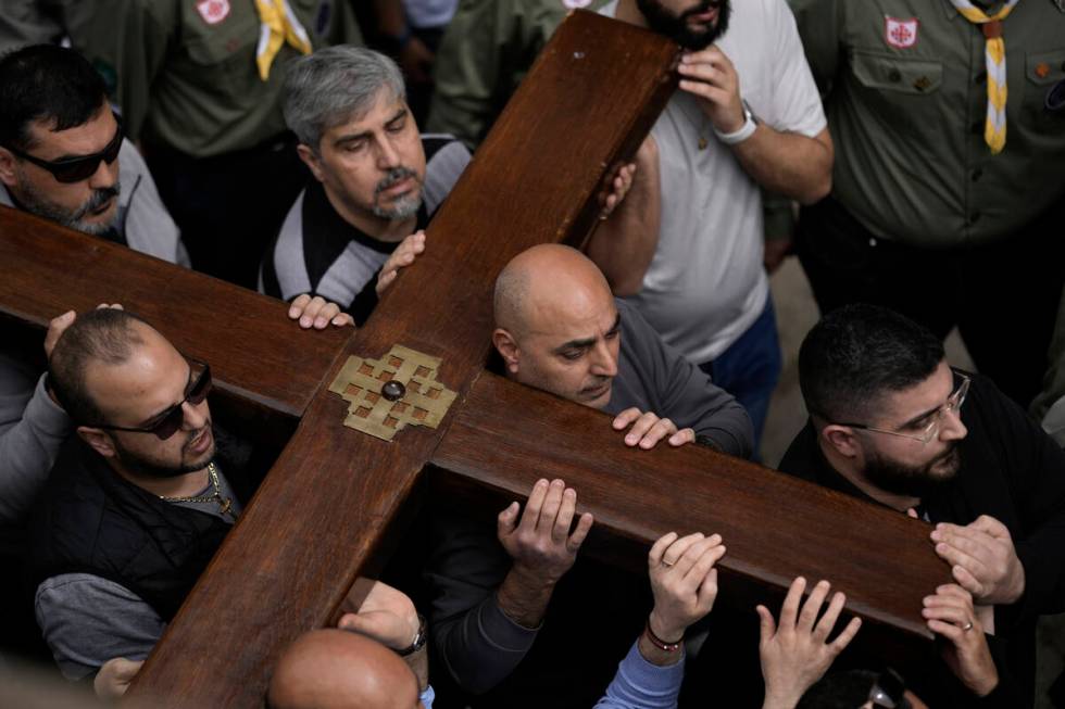 Christians walk the Way of the Cross procession that commemorates Jesus Christ's crucifixion on ...