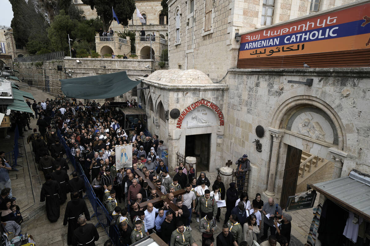 Christians walk the Way of the Cross procession that commemorates Jesus Christ's crucifixion on ...