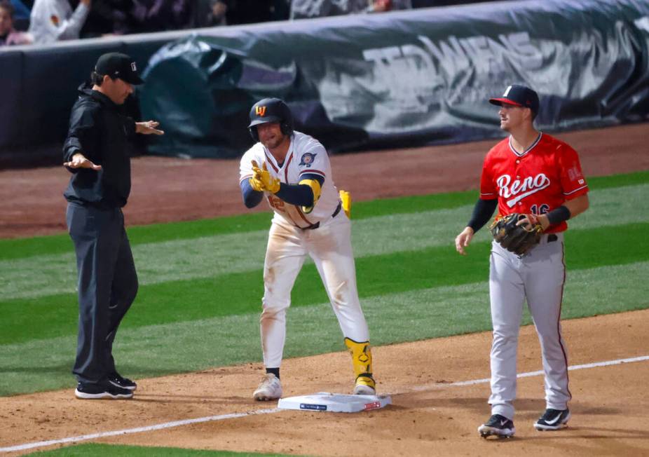 Aviators outfielder Max Schuemann reacts after being safe at third as Reno Aces third baseman K ...