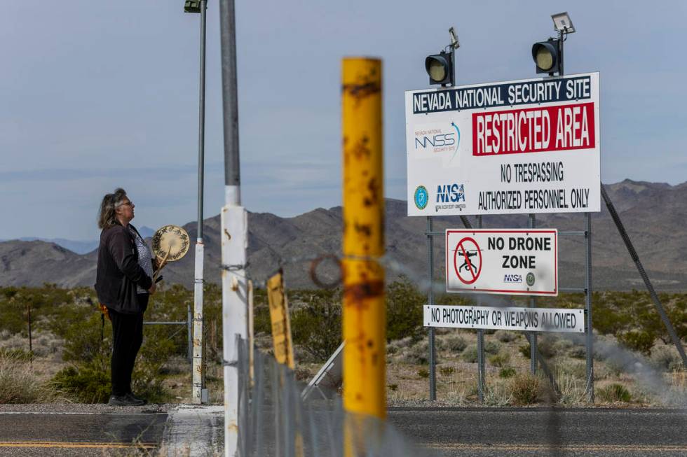 Donna Eyestone of Alameda, Calif., drums and chants at the entrance of the Nevada National Secu ...