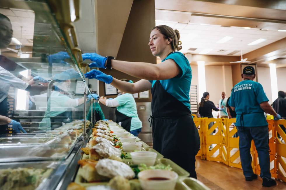 Volunteers help serve up an annual Easter meal at the Las Vegas Rescue Mission on Friday, March ...