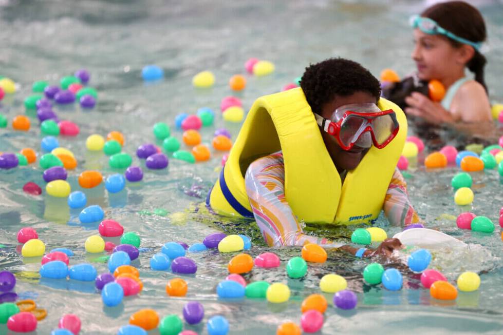 Hunters plunge for prizes during an Easter egg dive at Heritage Park Aquatic Complex on Sunday, ...