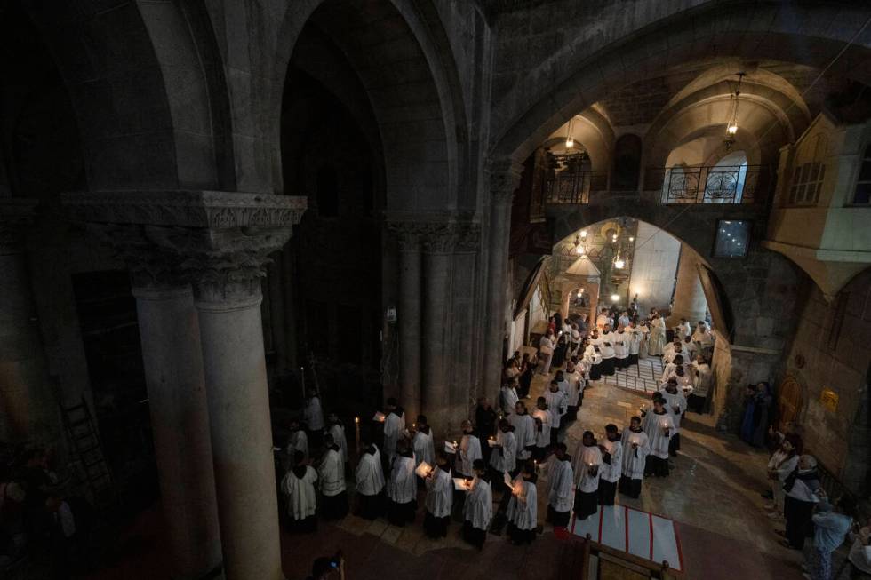 Clergymen walk in a procession around the Stone of Unction, which is traditionally claimed as t ...