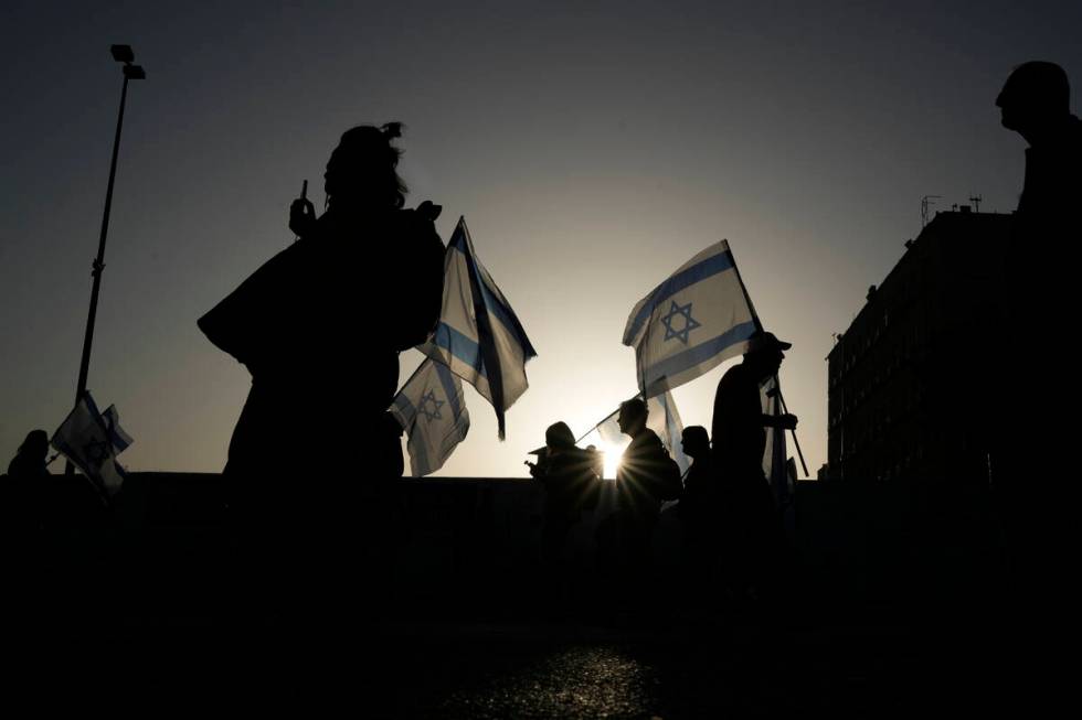 People take part in a protest against Israeli Prime Minister Benjamin Netanyahu's government an ...