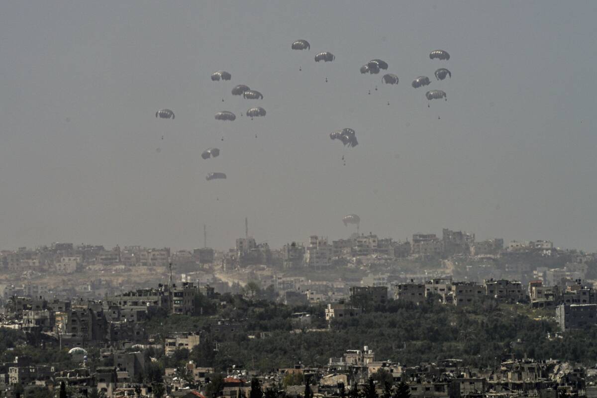 An aircraft airdrops humanitarian aid over the northern Gaza Strip, as seen from southern Israe ...