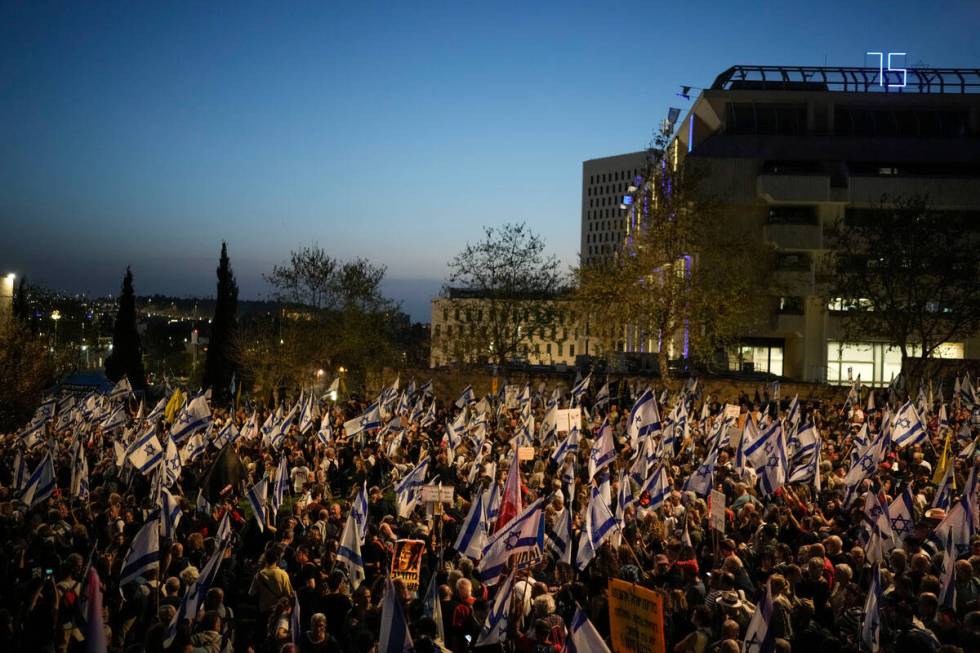 People take part in a protest against Israeli Prime Minister Benjamin Netanyahu's government an ...