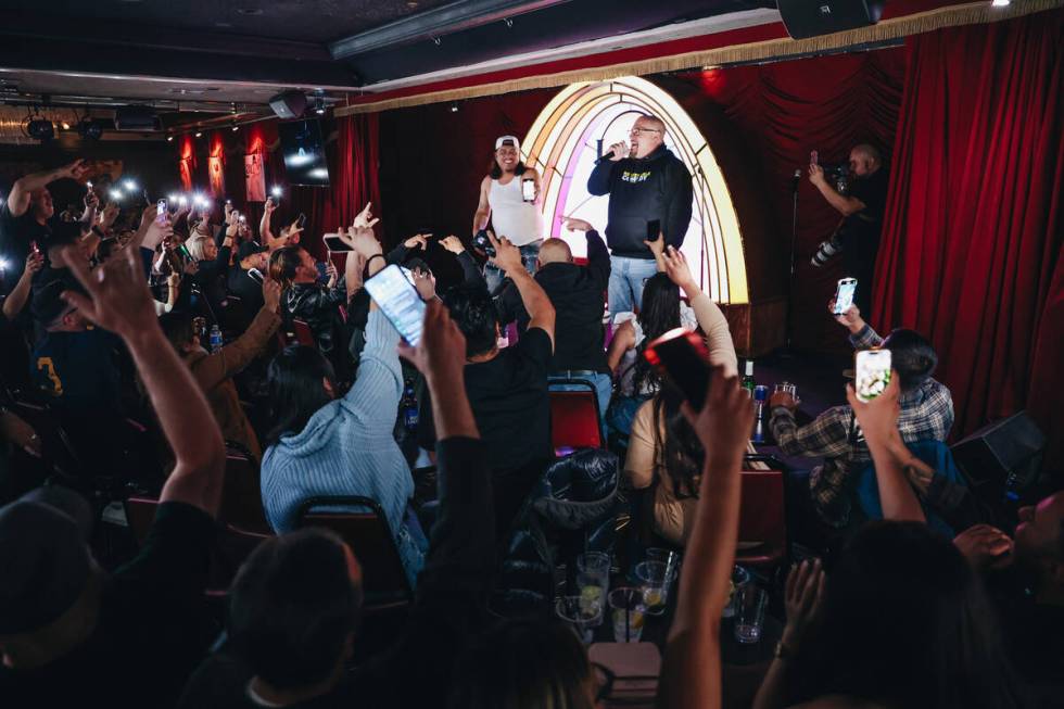 Crowd members wave their phone flashlights in the air during a stand-up by Concrete at the Laug ...