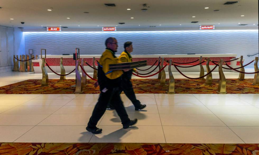 A security team delivers pizza to the near empty registration area during the final night of ga ...