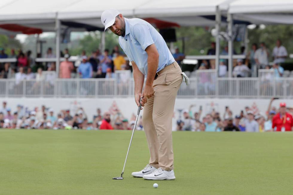 Scottie Scheffler watches a putt on the 18the green during the final round of the Houston Open ...