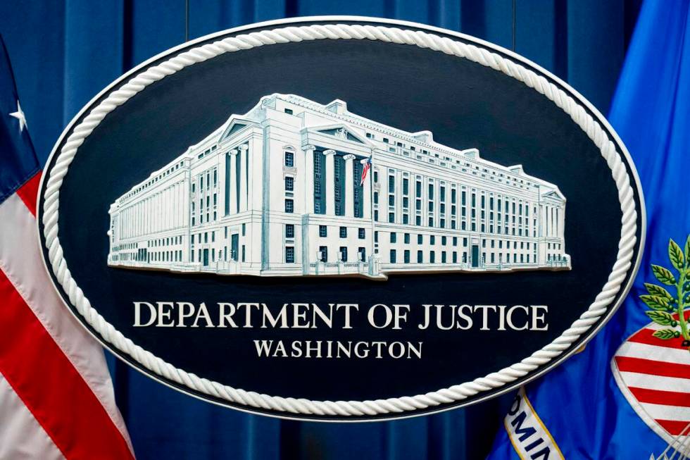 FILE - A U.S. Department of Justice sign is seen, Nov. 18, 2022, in Washington. (AP Photo/Andre ...