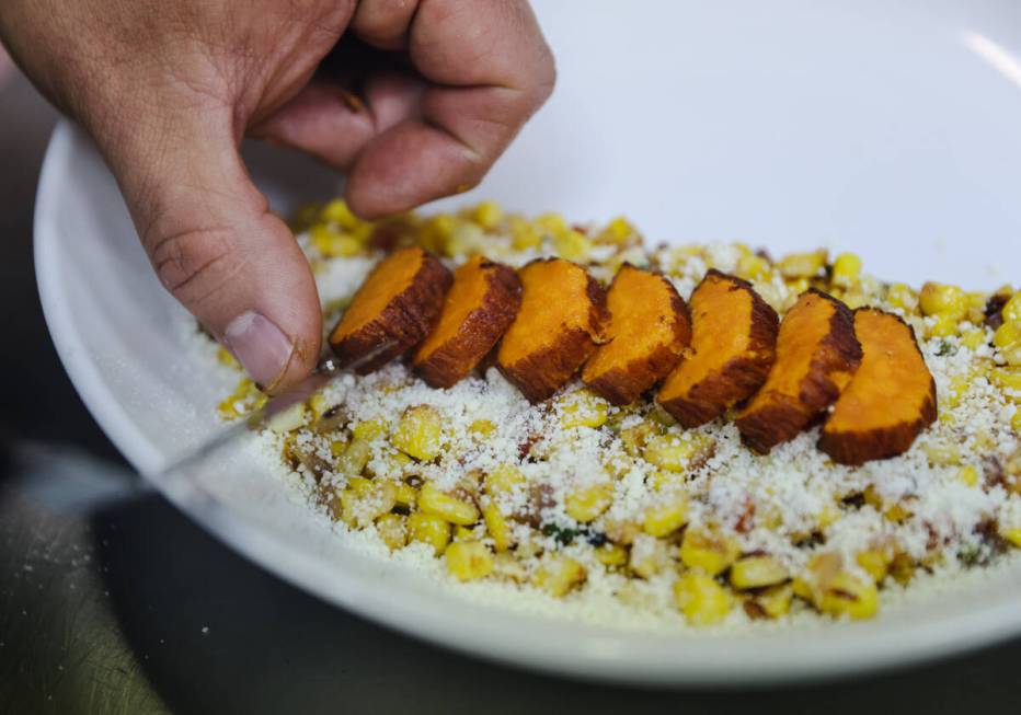 Chef and owner Steve Kestler prepares beef short ribs with mole, roasted sweet potatoes and esq ...