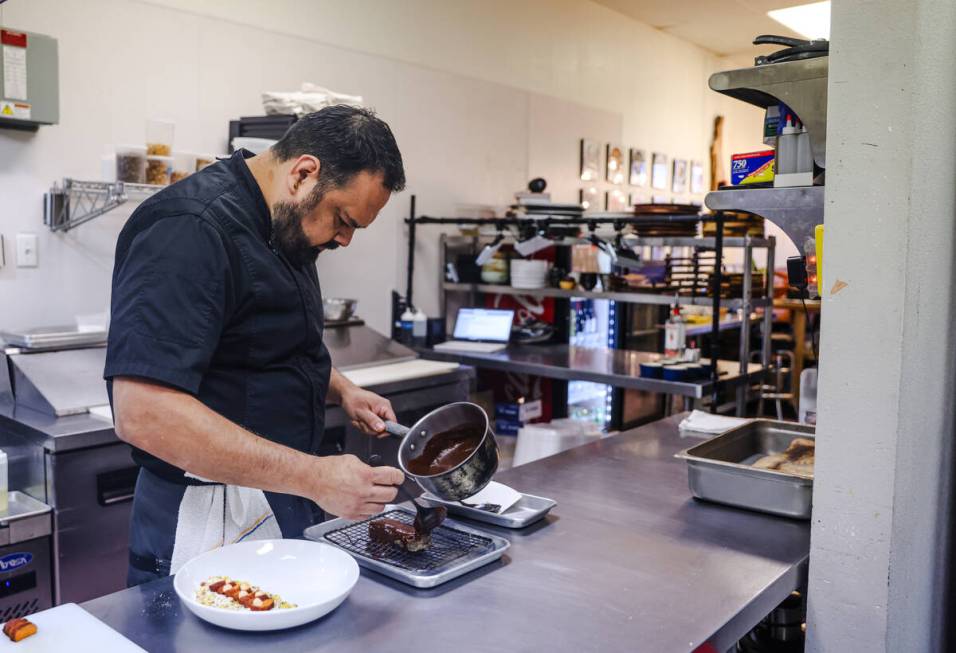 Chef and owner Steve Kestler prepares beef short ribs with mole, roasted sweet potatoes and esq ...