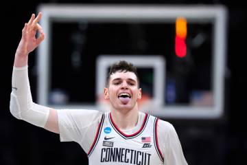 UConn center Donovan Clingan (32) celebrates after hitting a 3-pointer against Illinois during ...