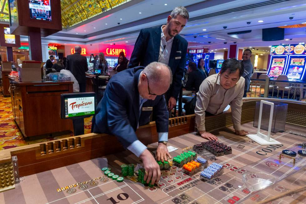 Chips are stacked and counted after the last craps game is concluded during the final night of ...