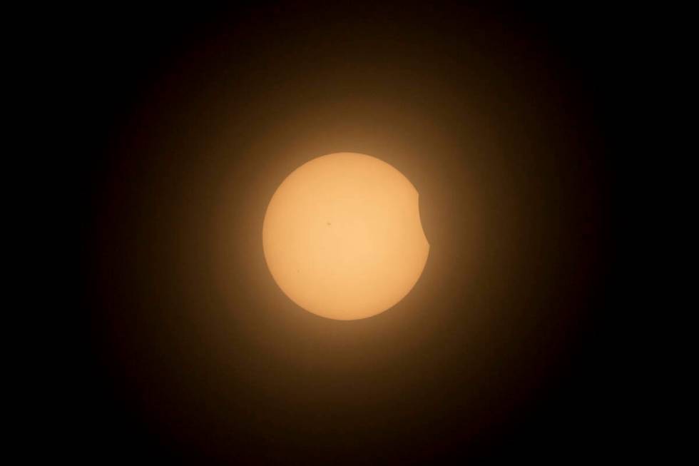 The moon partially covers the sun during a total solar eclipse in Mazatlan, Mexico, Monday, Apr ...