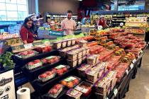 People shop at a grocery store in Glenview, Ill., Monday, July 4, 2022. (AP Photo/Nam Y. Huh)