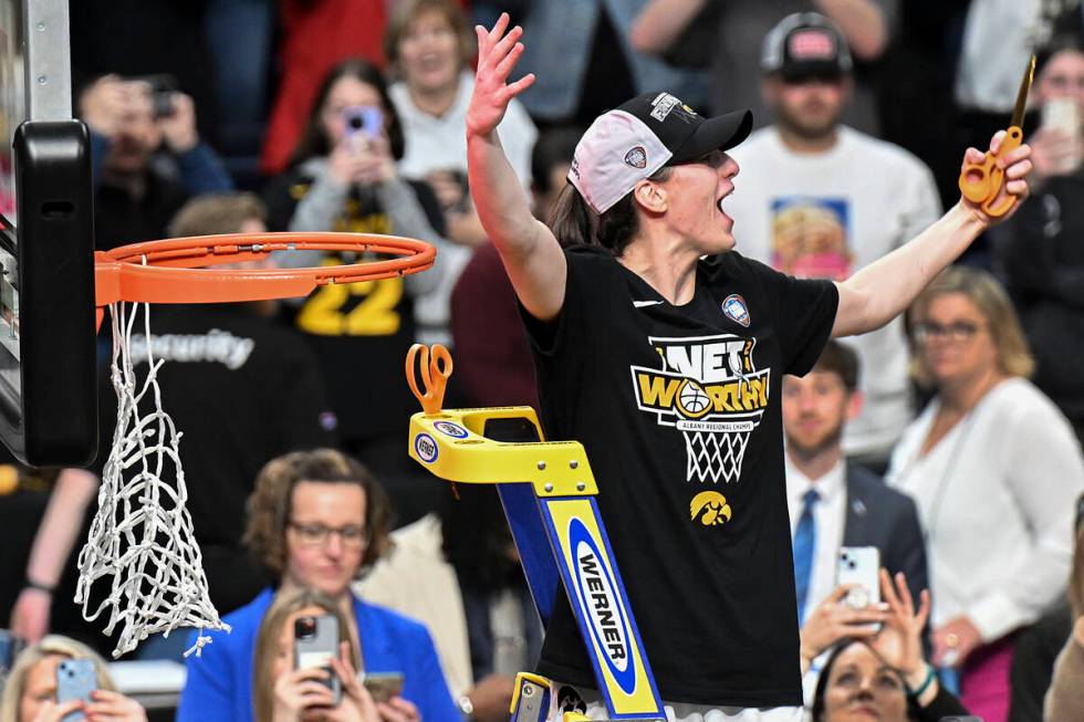 Iowa guard Caitlin Clark reacts to the crowd before cutting a piece of the net after Iowa defea ...