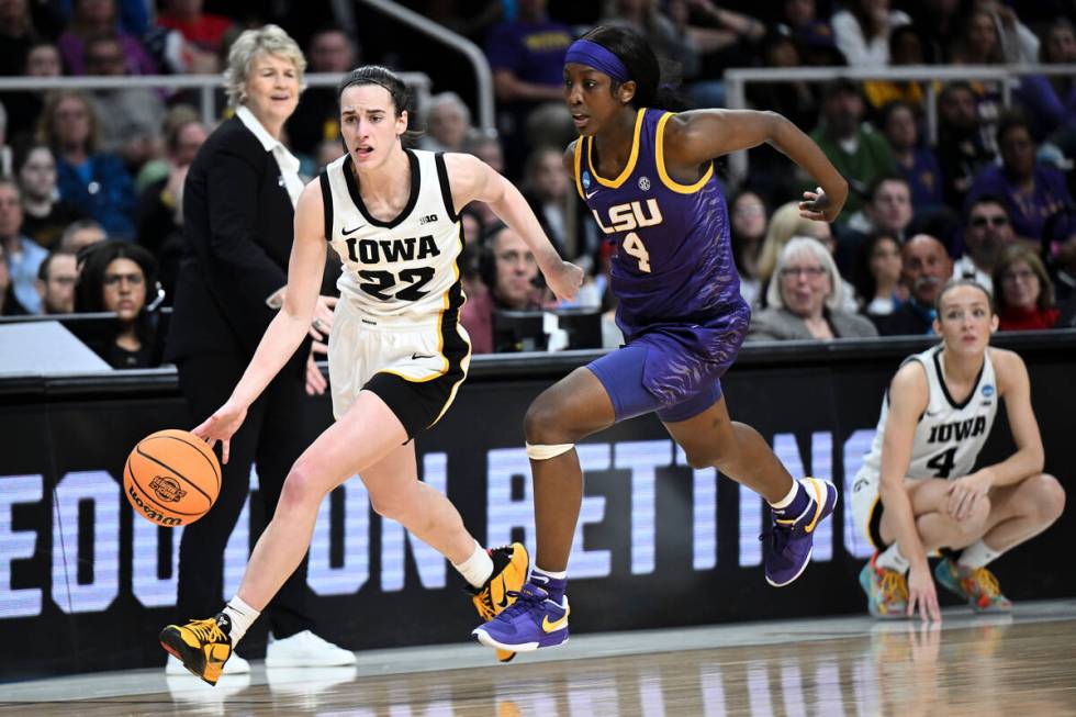 Iowa guard Caitlin Clark (22) drives down court against LSU guard Flau'jae Johnson (4) during t ...