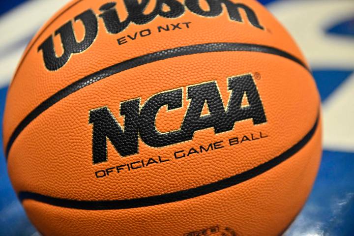 An official game ball sits on the court during the second half of an NCAA college basketball ga ...