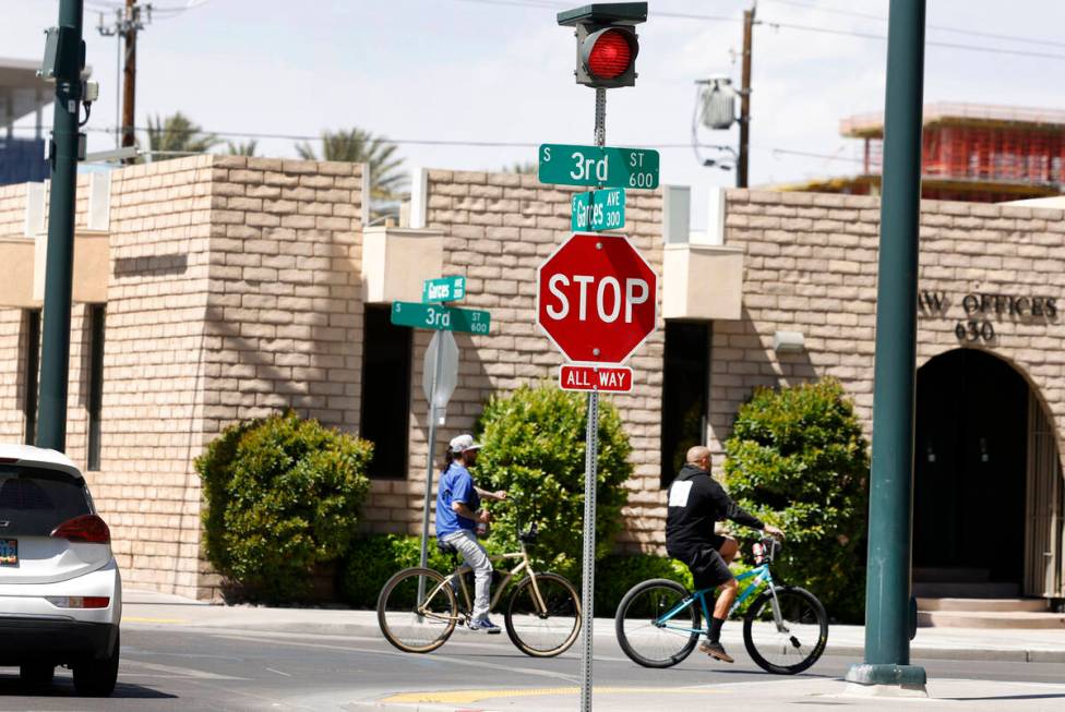 Cyclists ride past street signals recently added at the intersections of Third Street and Garce ...