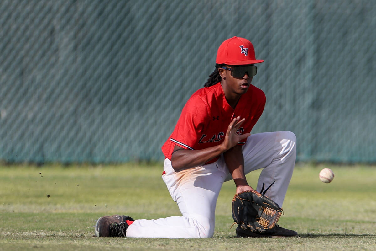 Las Vegas outfielder Keisean Ellzy bends to catch during a high school baseball game against Pa ...