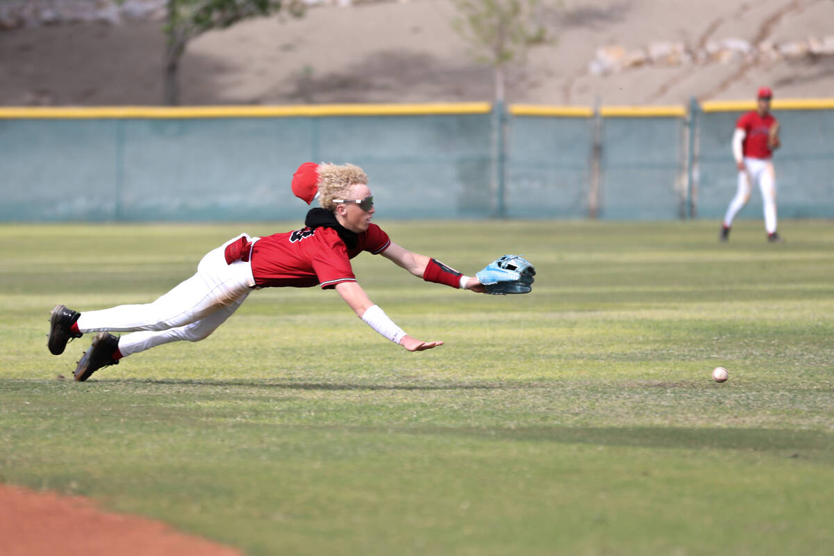 Las Vegas shortstop Kyle Iverson dives for the ball during a high school baseball game against ...