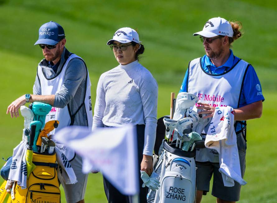 Rose Zhang, center, stands with caddie Brett Olly, right, and another on hole #7 during the sec ...