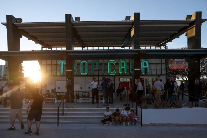 A sign from the now-shuttered Tropicana hotel-casino is lit for the first evening at the Neon M ...