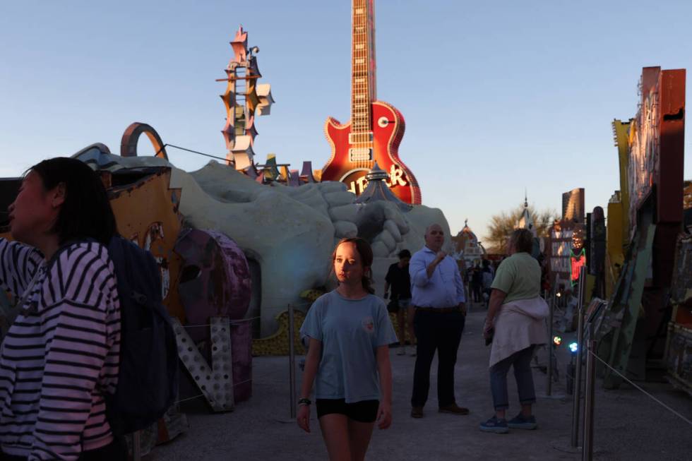 Visitors to the Neon Museum wander through the historic signs on Wednesday, April 3, 2024, in L ...