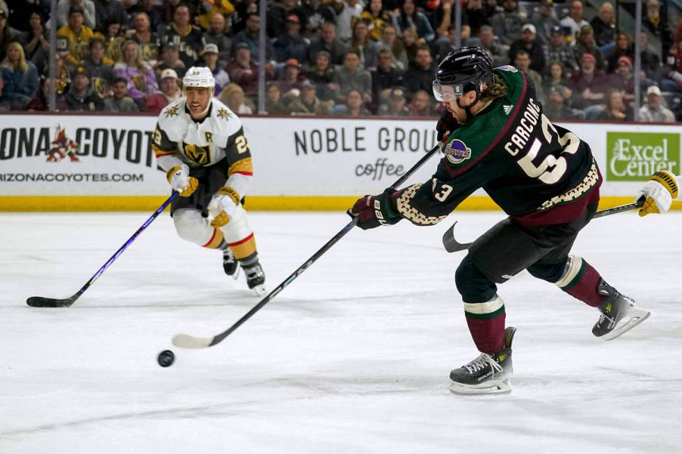 Arizona Coyotes left wing Michael Carcone (53) shoots as Vegas Golden Knights defenseman Alec M ...