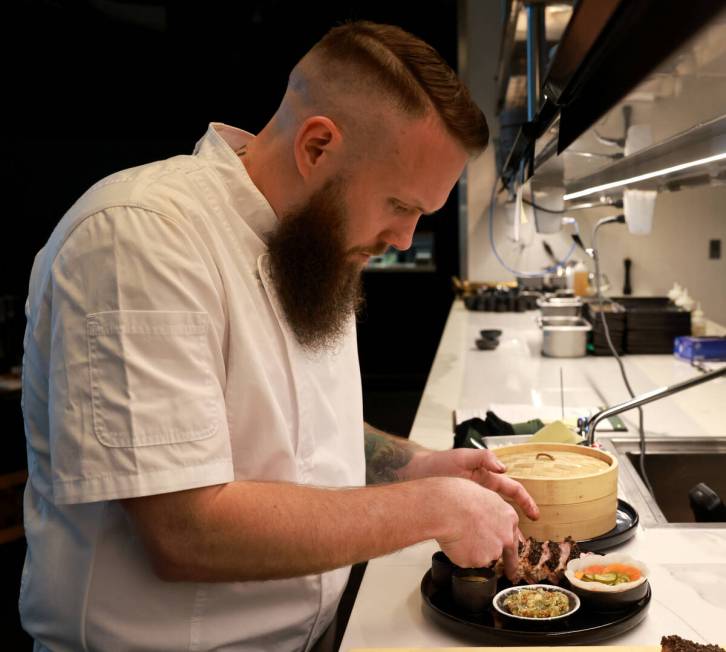 Corporate executive chef Christopher Arellanes plates pork belly pastrami, served with bao and ...