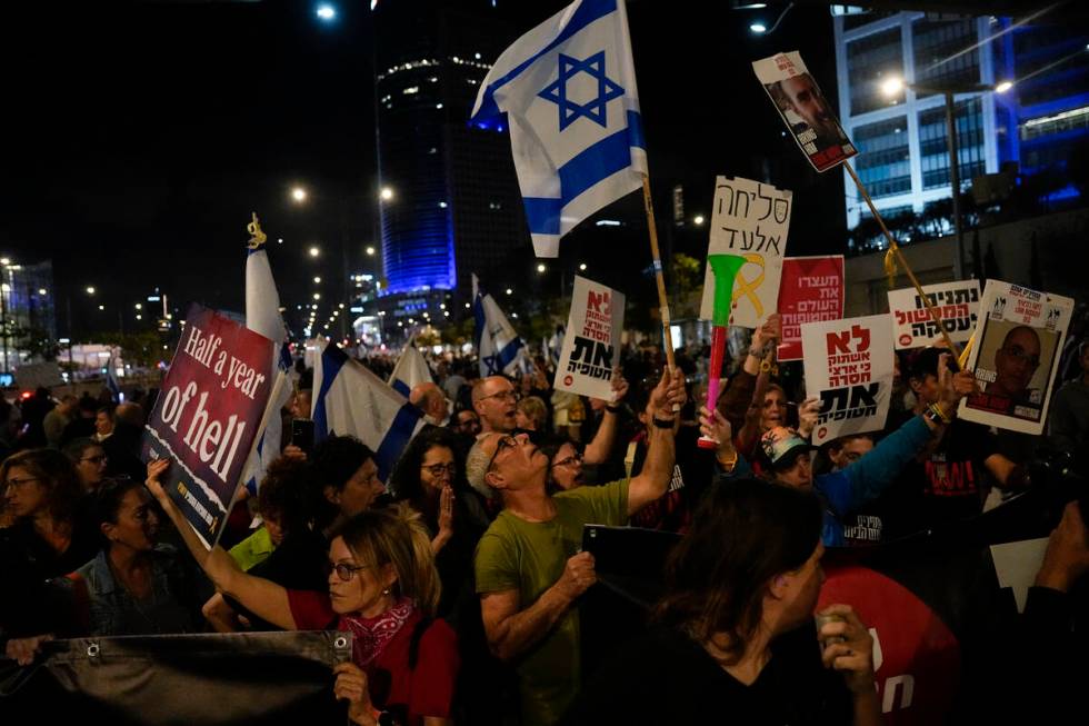 People take part in a protest against Israeli Prime Minister Benjamin Netanyahu's government an ...