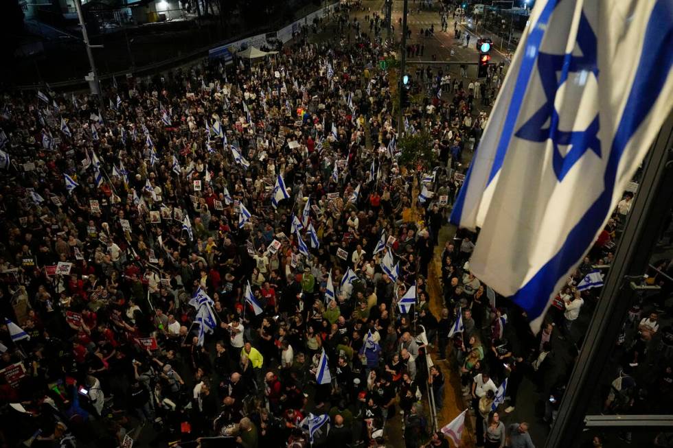 People take part in a protest against Israeli Prime Minister Benjamin Netanyahu's government an ...