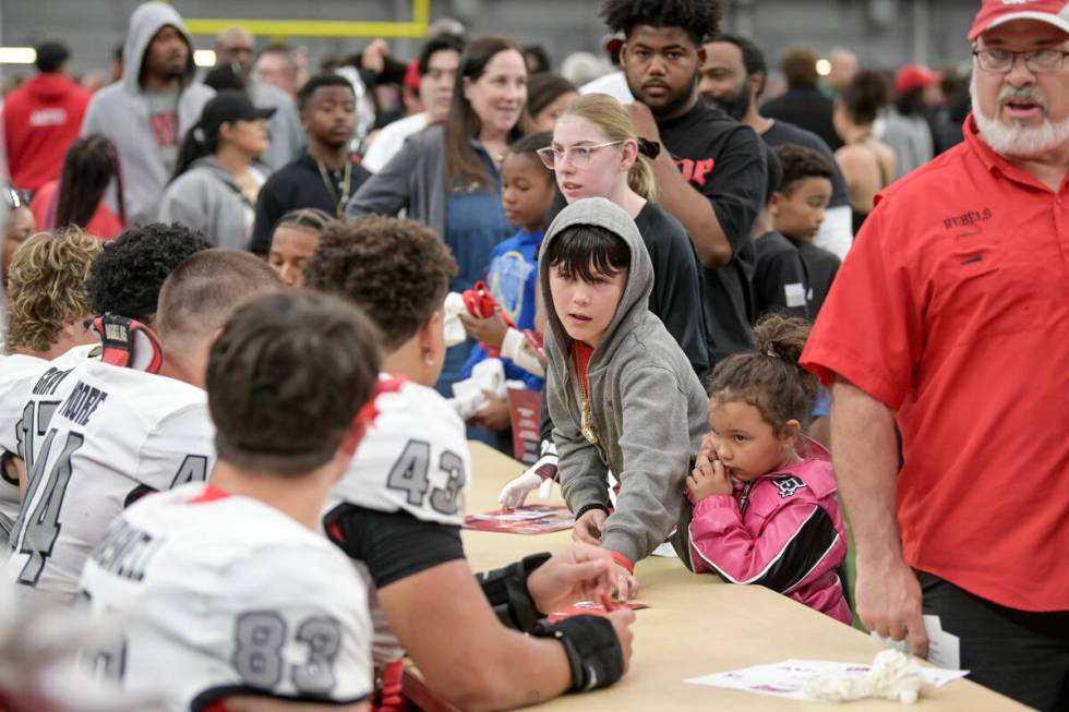 Fans line up for player autographs during UNLV football’s Spring Showcase scrimmage Satu ...