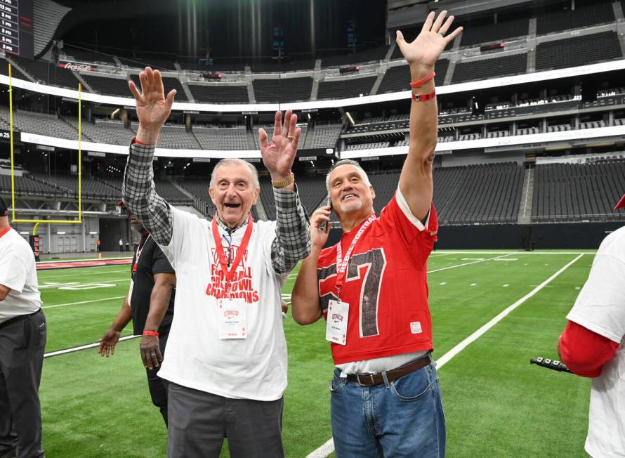 Former UNLV head coach Harvey Hyde and player Ron Drake wave to fans during UNLV football&#x201 ...