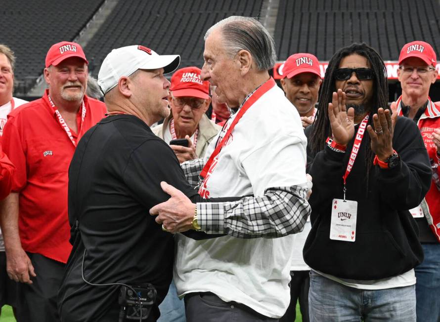 Current UNLV head coach Barry Odom talks to former head coach Harvey Hyde during UNLV football& ...