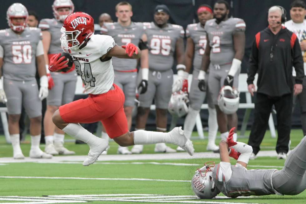 UNLV running back Darrien Jones gets past defensive back Tre Fulton during UNLV football&#x2019 ...