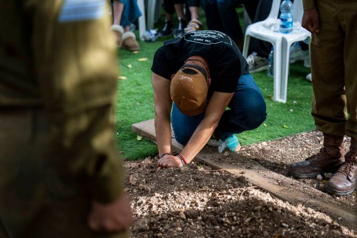 Avraham Harush, father of Israeli solider Sergeant Reef Harush, mourns over his grave in Ramat ...