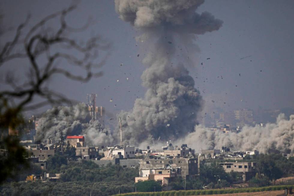 Smoke rises following an Israeli airstrike in the Gaza Strip, as seen from southern Israel, Mon ...