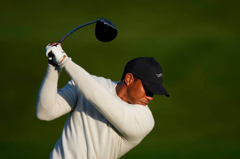 Tiger Woods hits on the driving range during a practice round in preparation for the Masters go ...