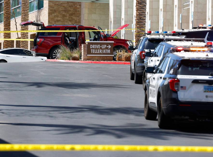 An SUV is seen at the scene as Las Vegas police investigate a shooting at City National Bank Bu ...