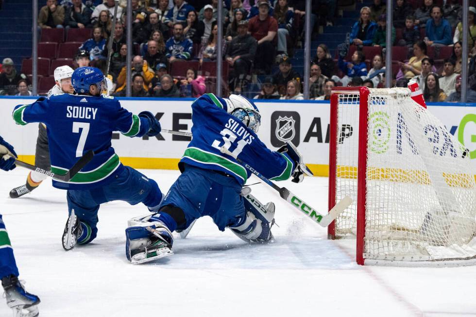 Vegas Golden Knights' Jack Eichel (9) scores on Vancouver Canucks goaltender Arturs Silovs (31) ...