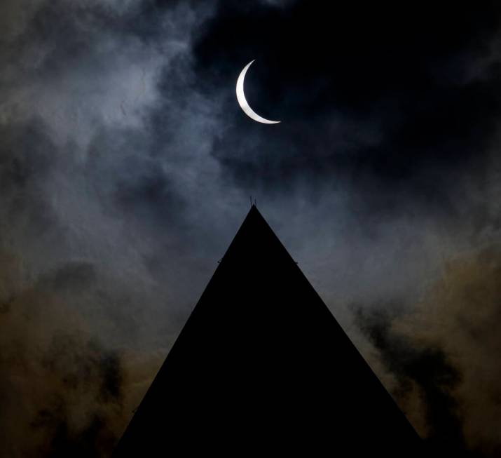 The moon is seen passing in front of the sun with the top of the Washington Monument in silhoue ...