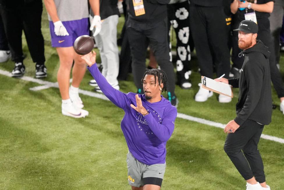 LSU quarterback Jayden Daniels runs through passing drills during LSU's NCAA football pro day i ...