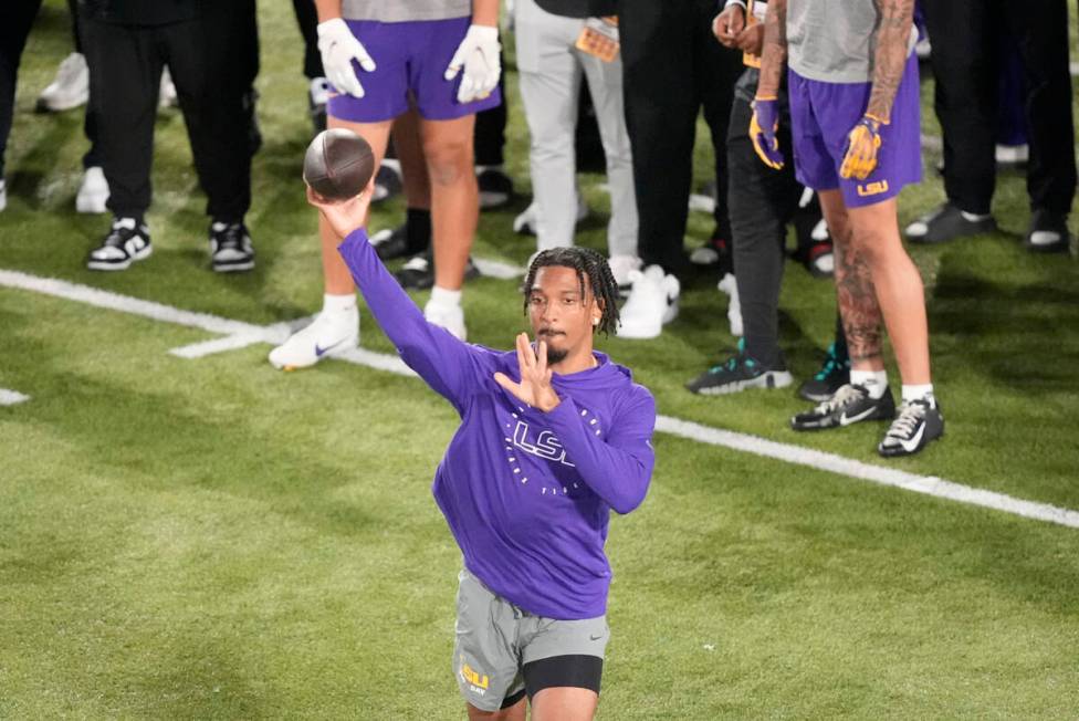 LSU quarterback Jayden Daniels runs through passing drills during LSU's NCAA football pro day i ...