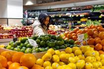 A woman browses produce for sale at a grocery store, Friday, Jan. 19, 2024, in New York. In fin ...