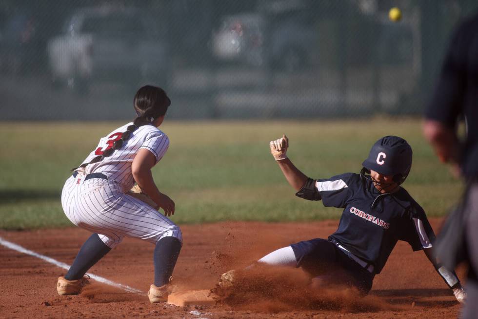 Coronado's Alohi Mundon, right, slides safely into third base while Liberty's Ciana Cubi (3) an ...