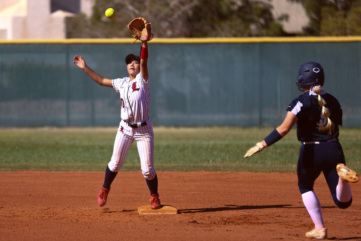 Liberty's Vanessa Saenz (10) reaches to catch for an out on Coronado's Kendall Selitzky, who ru ...