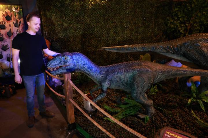 Founder and owner Tim Clothier, posing with Hugo the Velociraptor, talks to a reporter inside D ...