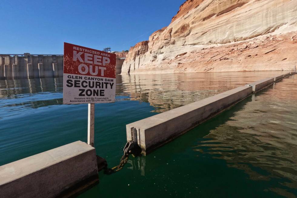 A sign reading "keep out" is displayed just upstream of Glen Canyon Dam at Lake Powell on June ...